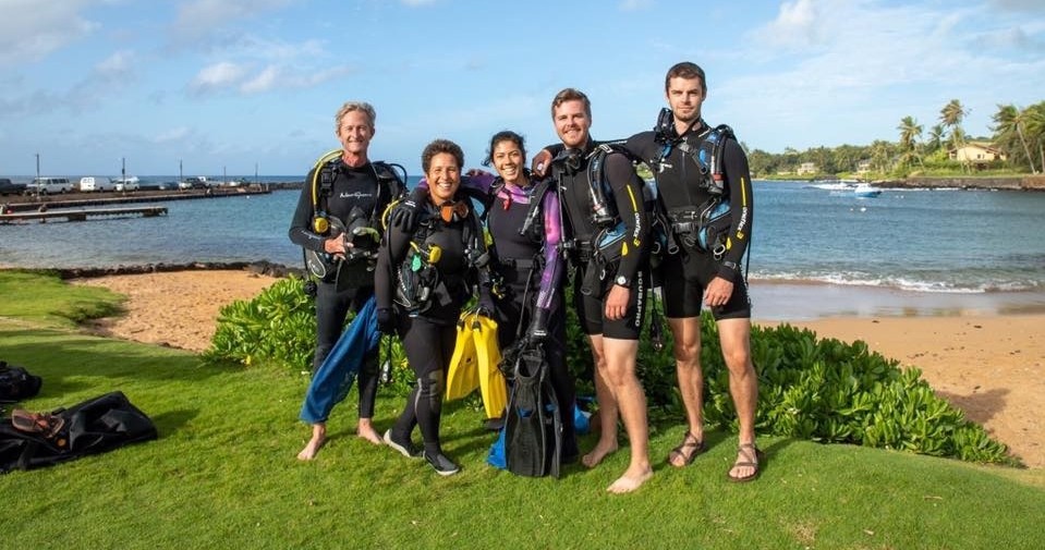Koloa Landing 2-Tank Shore Dive Image 1 a group of people standing next to a body of water