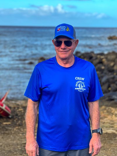 Staff_Photo_Bill_Hammond a man wearing a blue shirt standing in front of a body of water