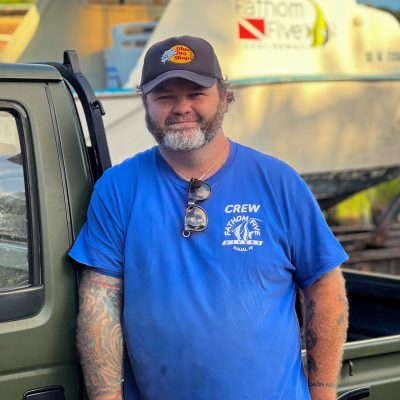 Staff_photo_noah_Blair a man wearing a blue hat