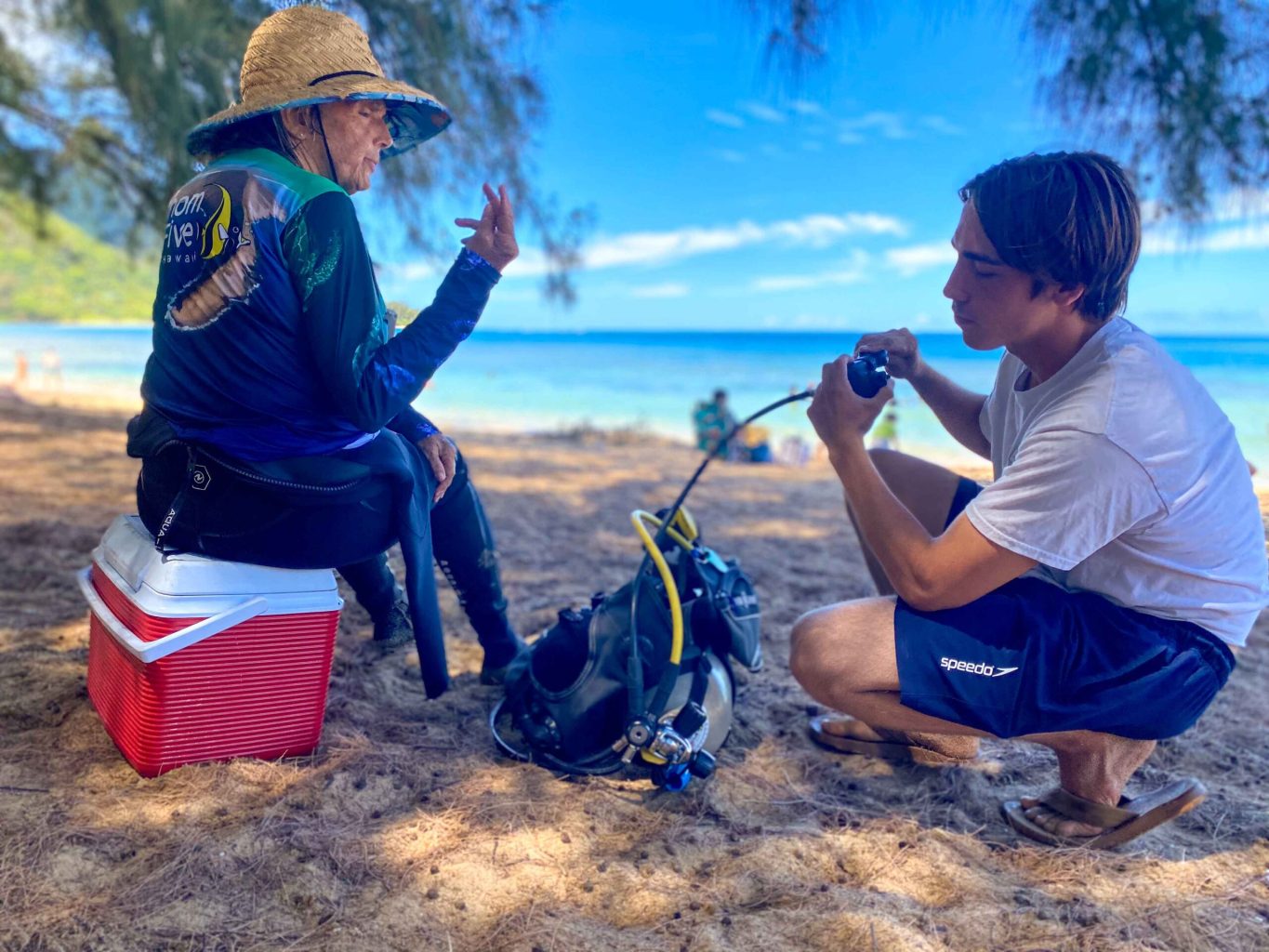 New Student learning about scuba basics from Owner of Fathom Five Jeannette Auber